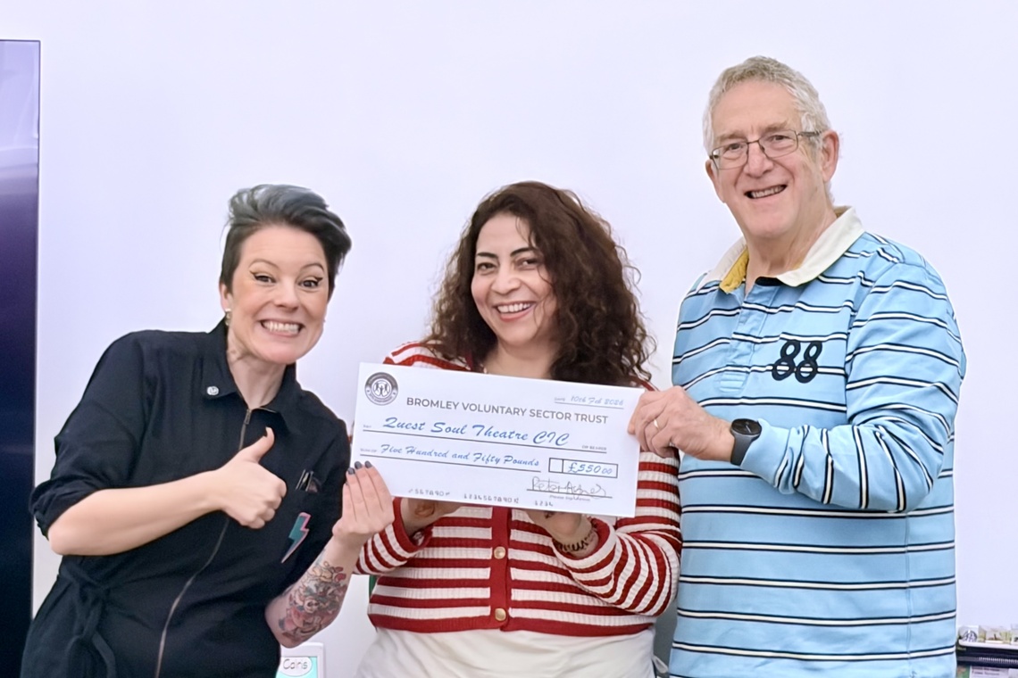 Mercedes from Quest Soul Theatre being presented with the money raised